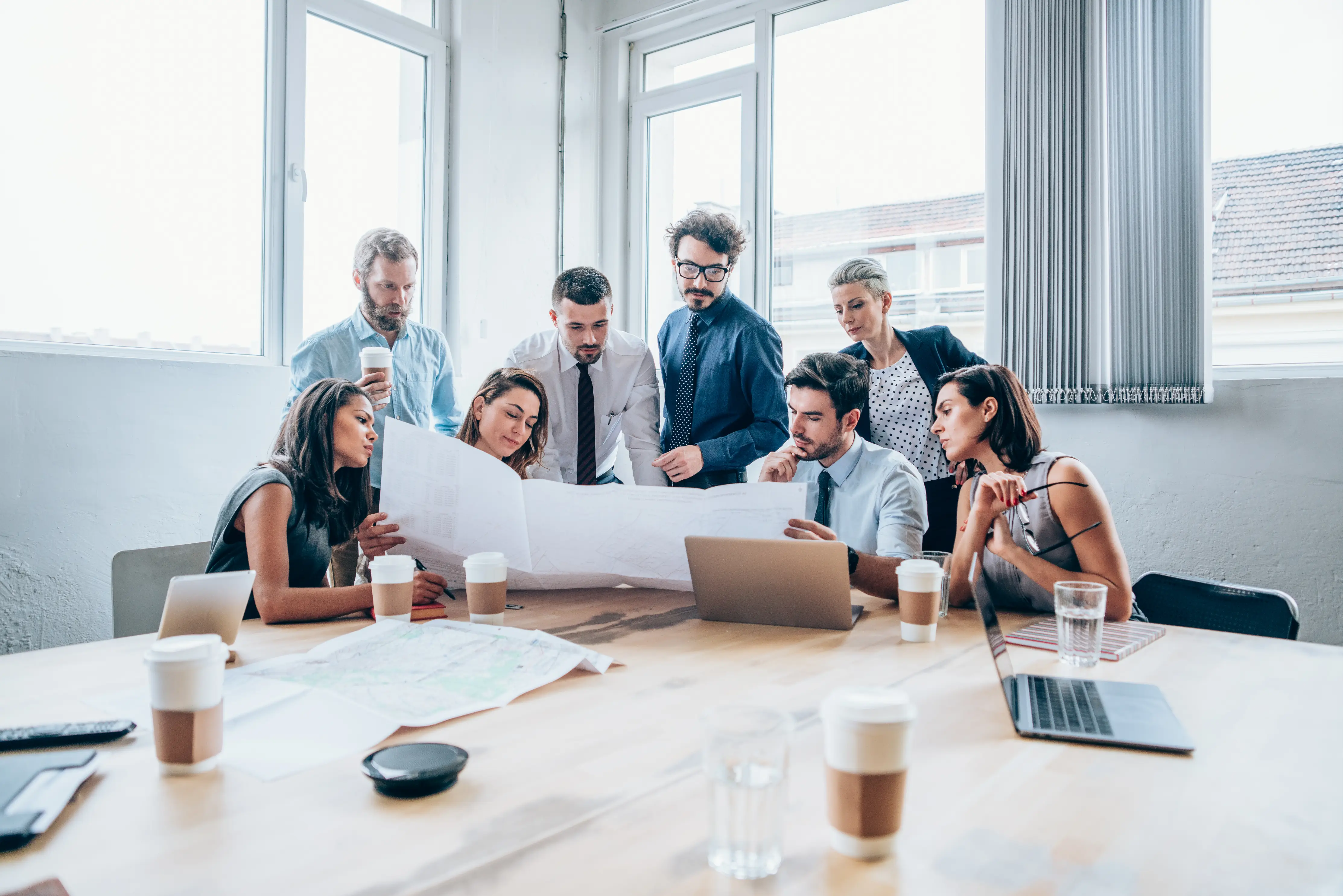 Team reviewing plans around a table